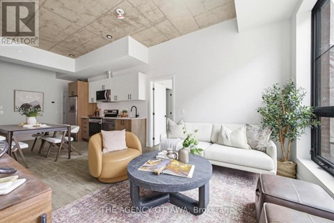 A living room with a grey coffee table and a white couch.
