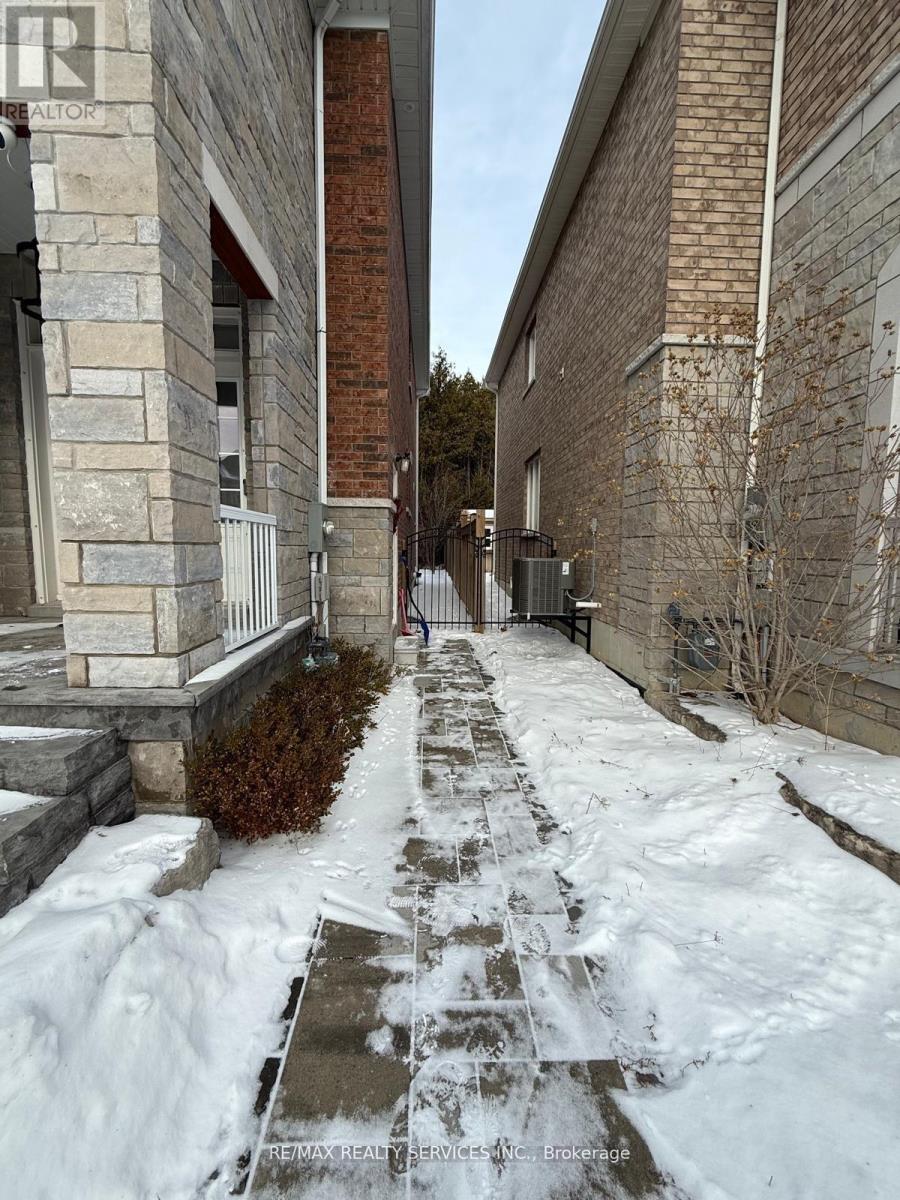 A snow-covered walkway leads to a building with a sign that reads "RE/MAX Realty".