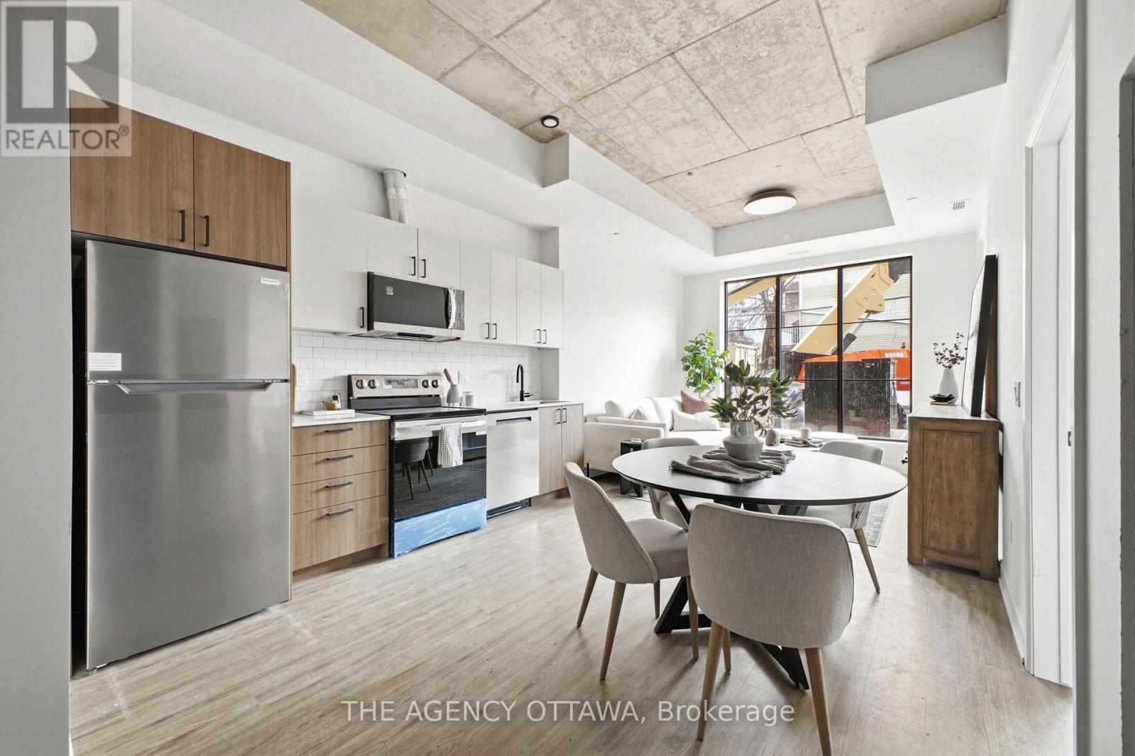 A modern kitchen with a dining table and chairs.