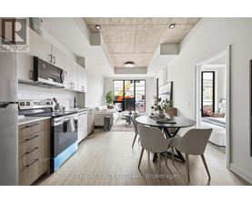 A modern kitchen with a dining table and chairs in the middle of the room.