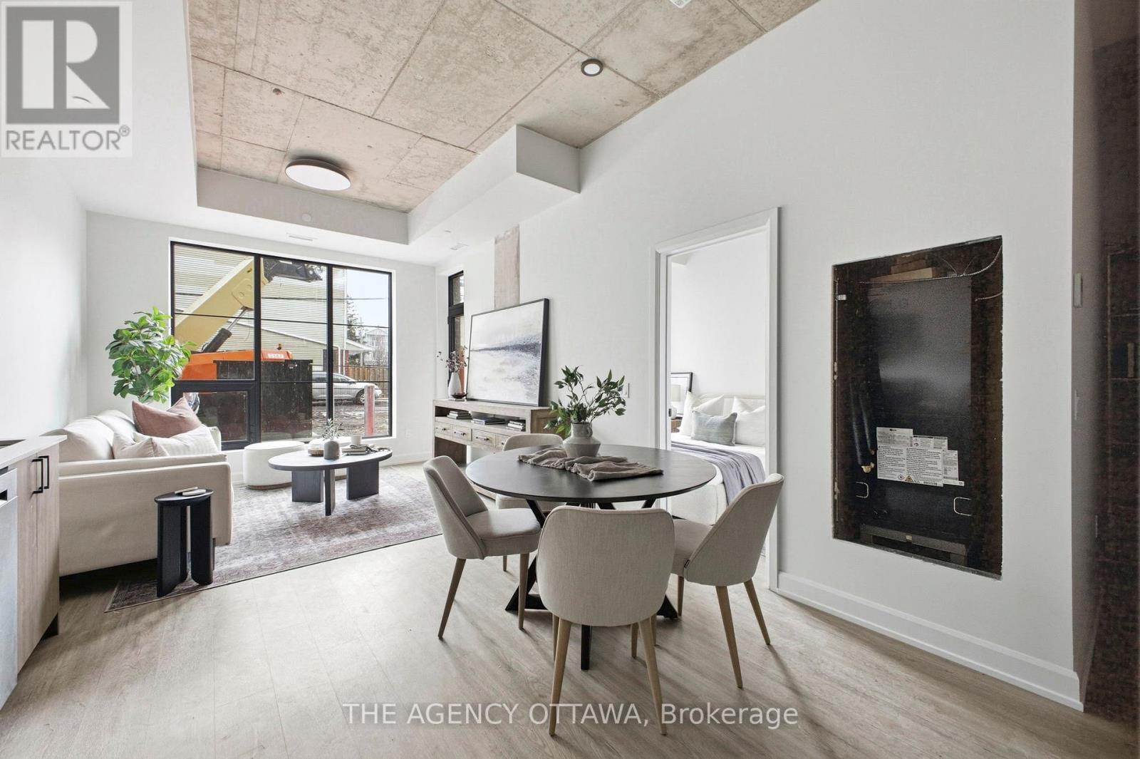 A modern living room with a dining table and chairs.