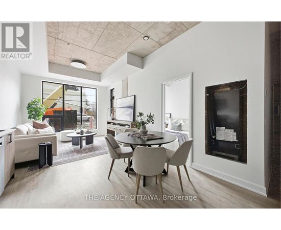 A modern living room with a dining table and chairs.