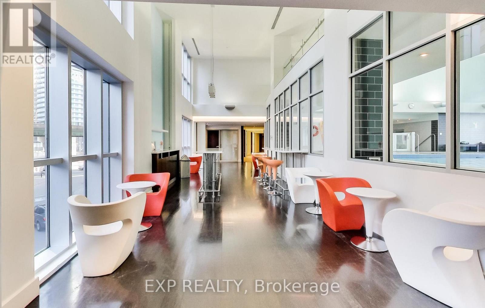 A modern office space with white and orange furniture.