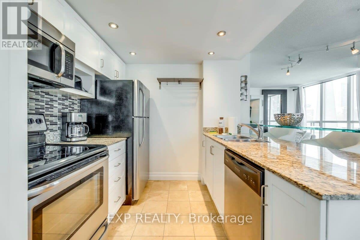 A kitchen with white cabinets and a granite countertop.