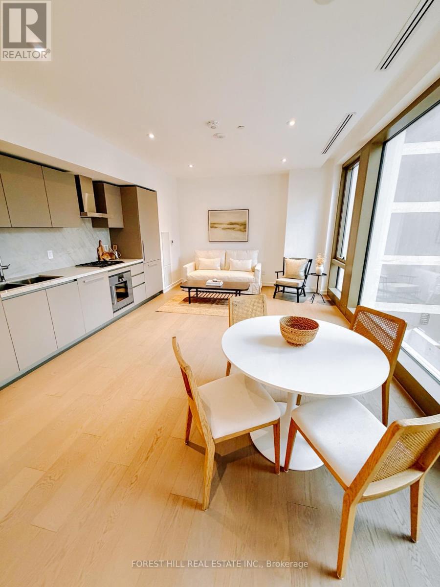A modern kitchen with a dining table and chairs.