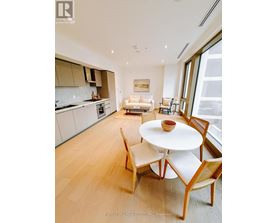 A modern kitchen with a dining table and chairs.