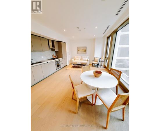 A modern kitchen with a dining table and chairs.