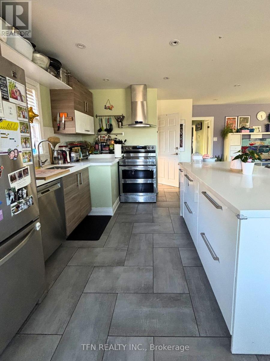 A kitchen with a refrigerator covered in magnets.