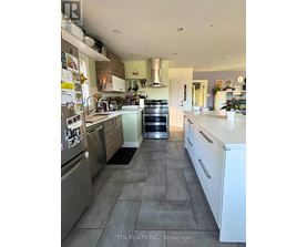 A kitchen with a refrigerator covered in magnets.