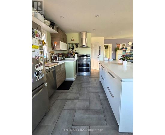 A kitchen with a refrigerator covered in magnets.