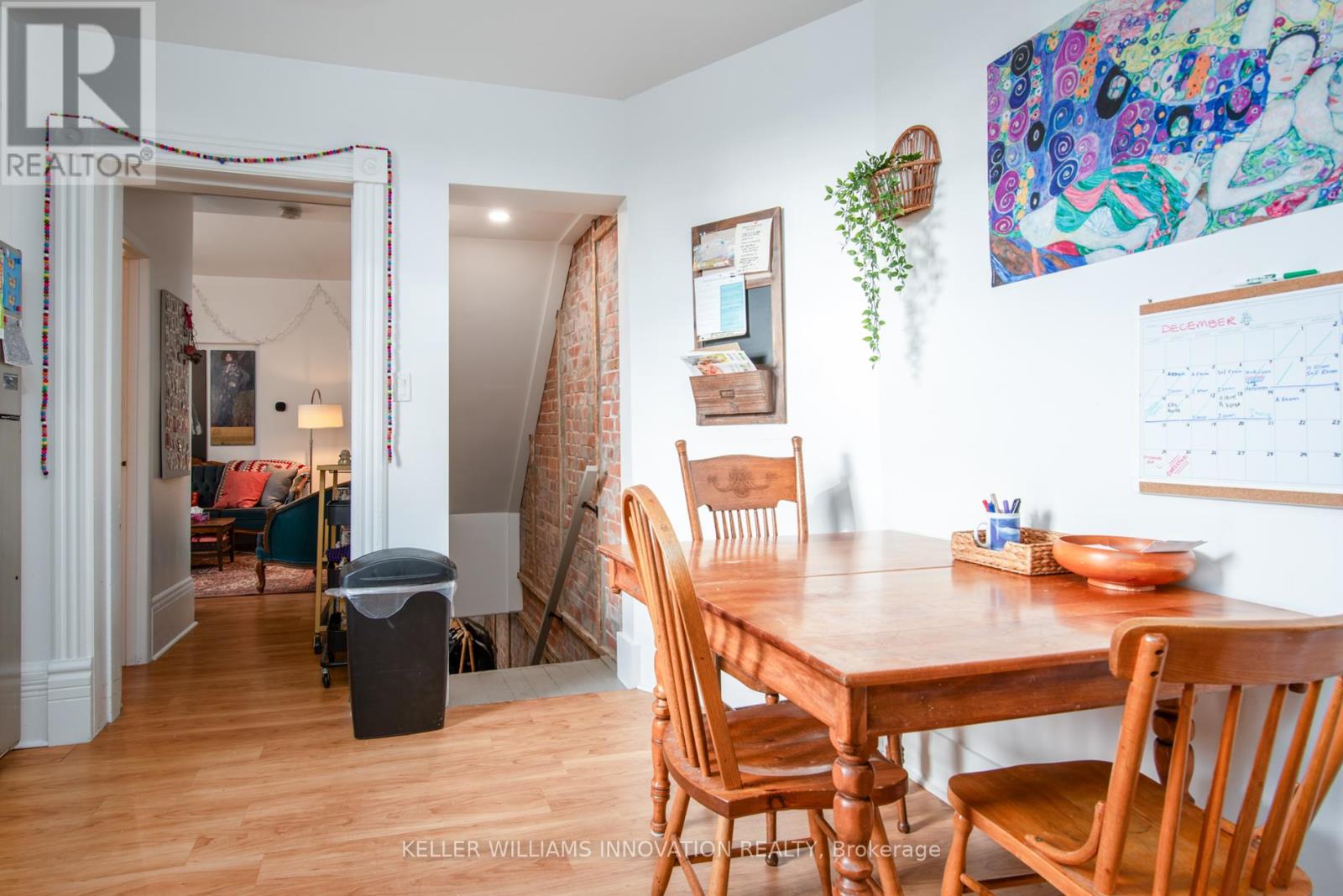 A dining room with a wooden table and chairs.