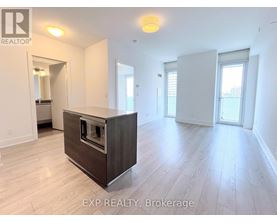 A spacious room with a built-in oven and wooden flooring.