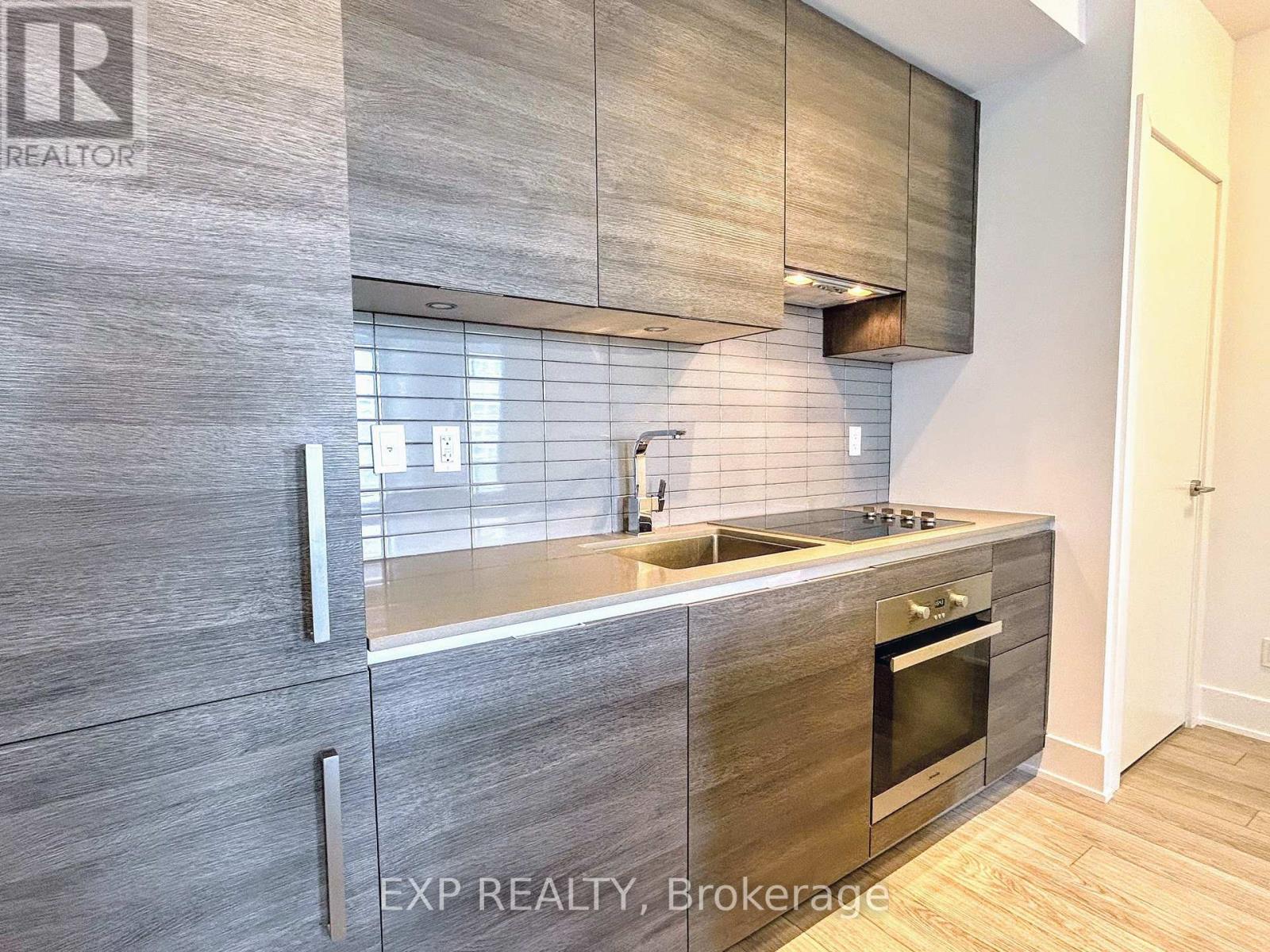 A modern kitchen with EXP Realty, Brokerage written on the wall.