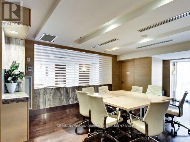 A conference room with a long table and chairs.