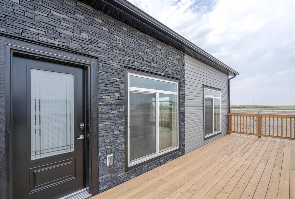 A house with a black door and a wooden deck.