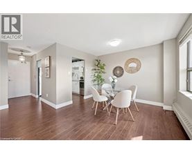 A dining room with a table and chairs.