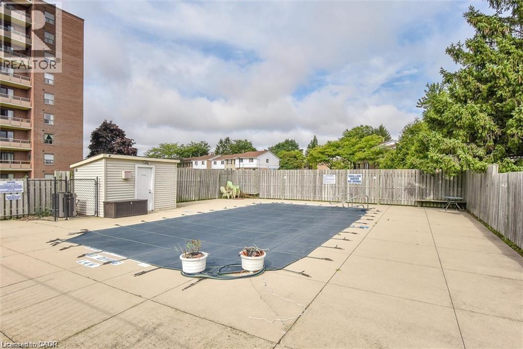 A backyard with a pool and a fence.