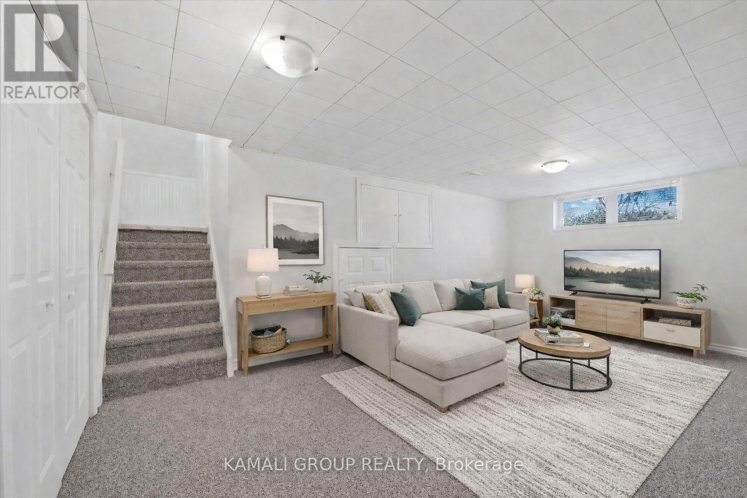 A living room with a couch, coffee table, and a television.