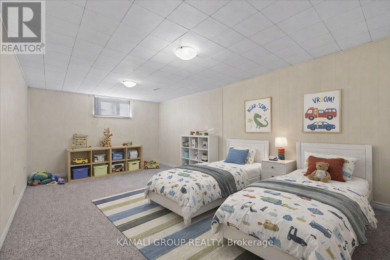 A bedroom with two beds and a carpeted floor.