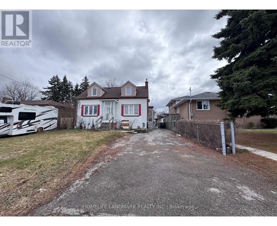 A realtor image of a house with a driveway and a white RV parked in front.