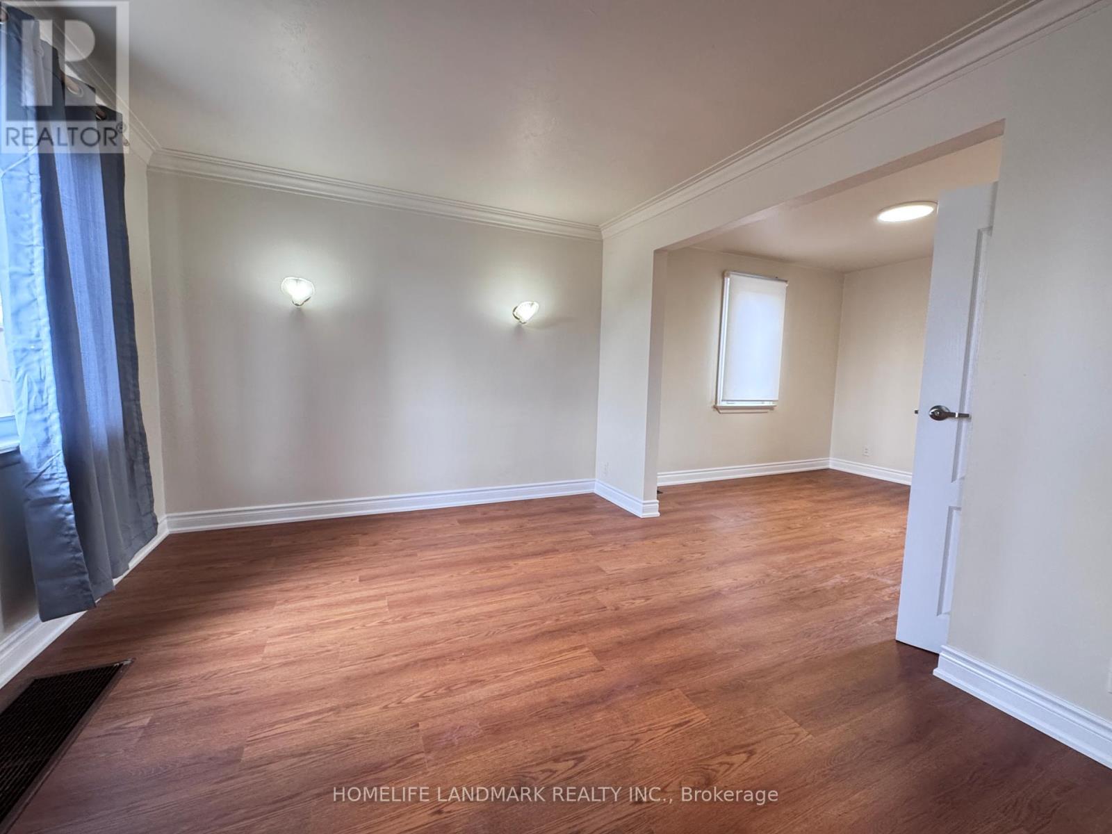 A room with wooden floors and white walls.