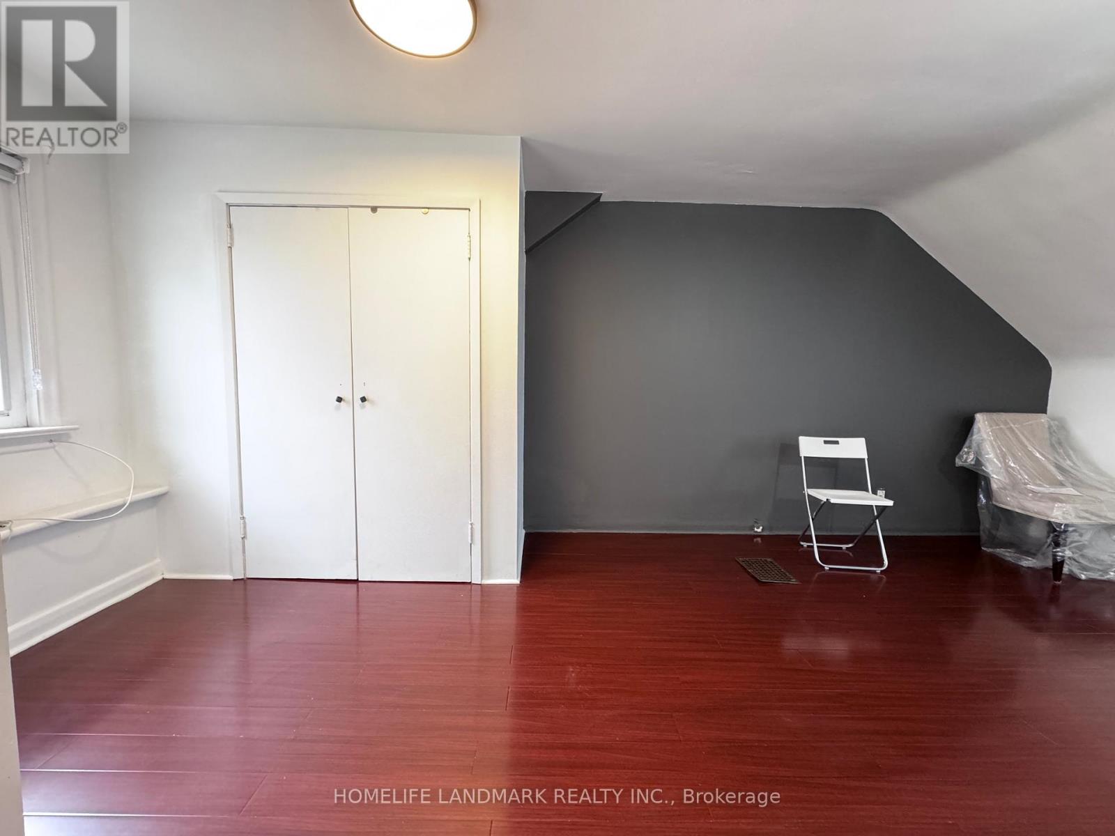 A room with a wooden floor and a white door.