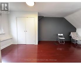 A room with a wooden floor and a white door.