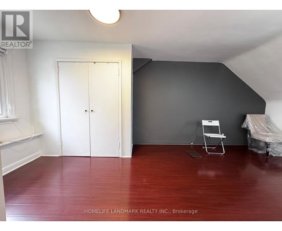 A room with a wooden floor and a white door.