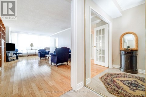 A living room with a blue couch and a rug.