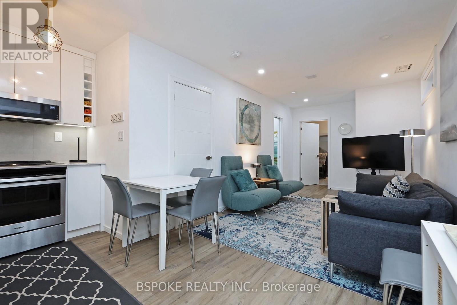 A modern kitchen with a dining table and chairs.