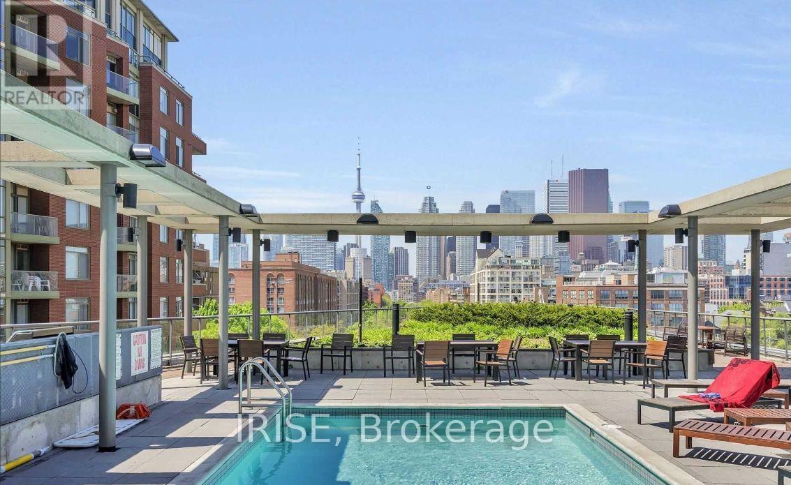 A pool area with a view of the city skyline.