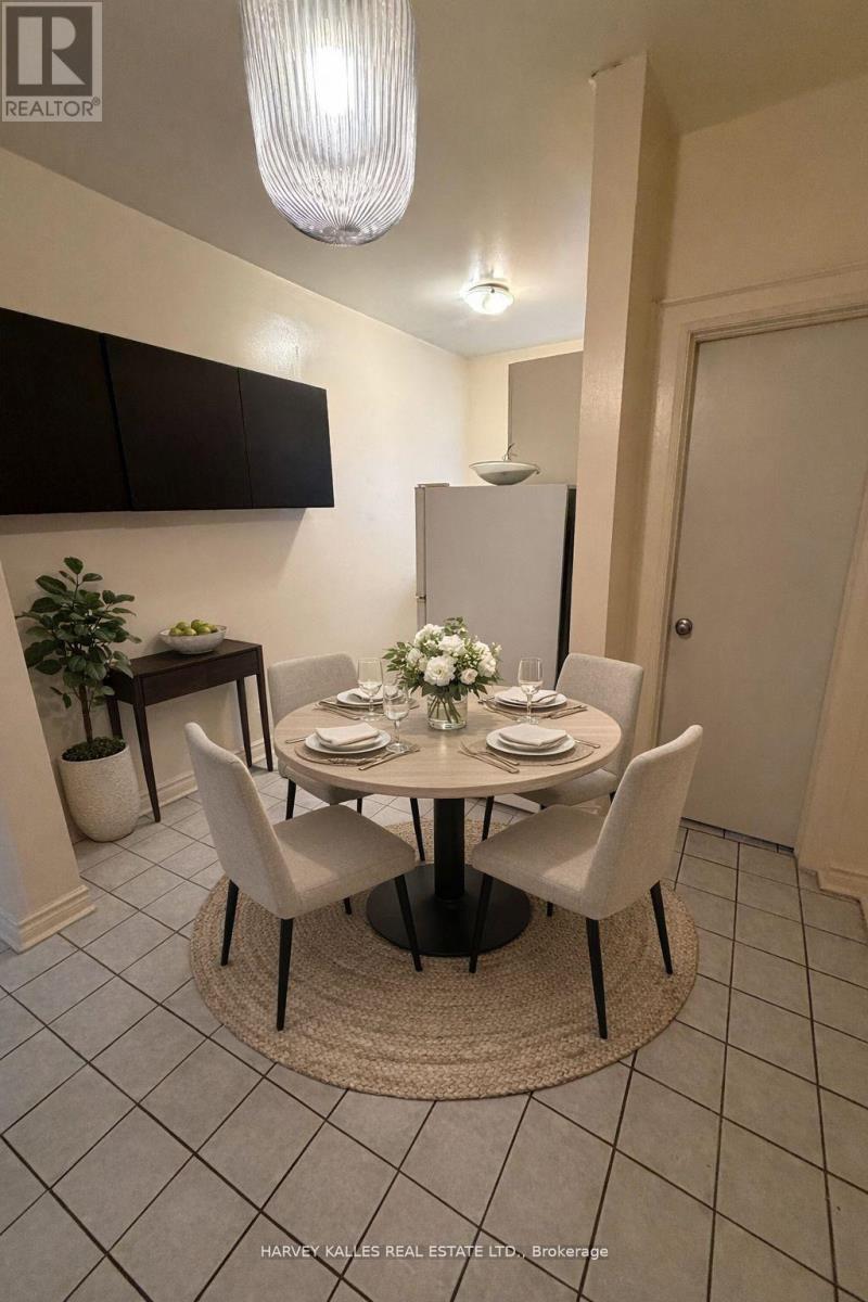 A dining room with a round table set for four.