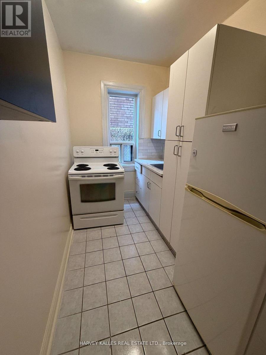 A kitchen with white appliances and cabinets.