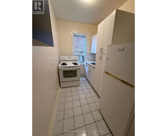 A kitchen with white appliances and cabinets.