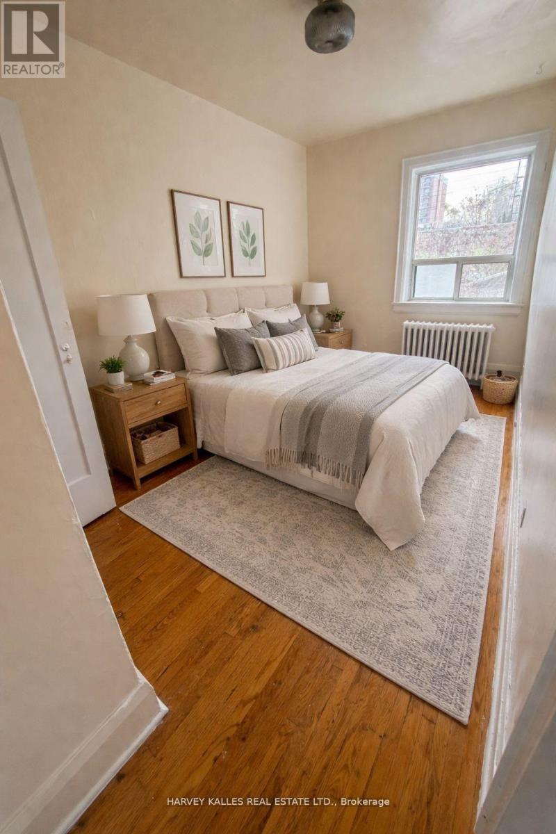 A bedroom with a large bed and a window.