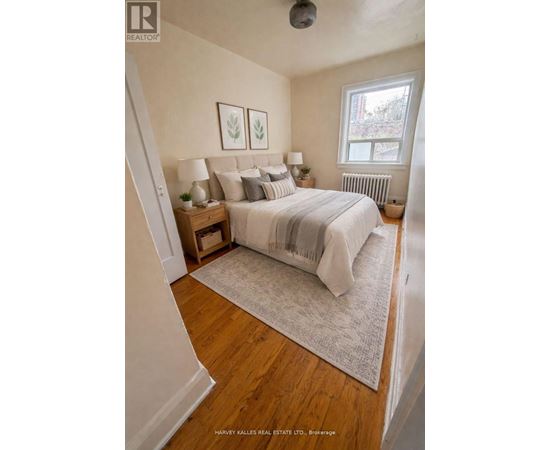 A bedroom with a large bed and a window.