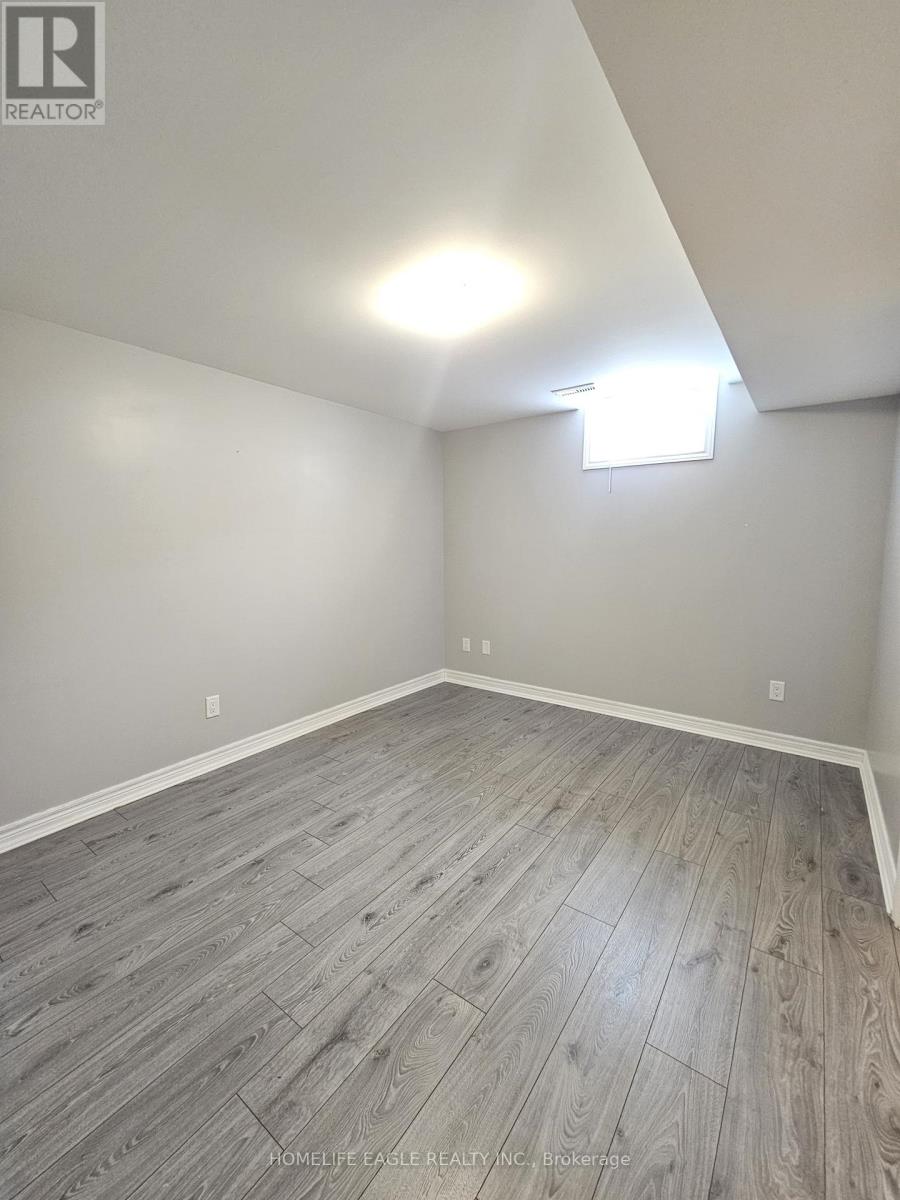 A room with wooden flooring and a light on the ceiling.