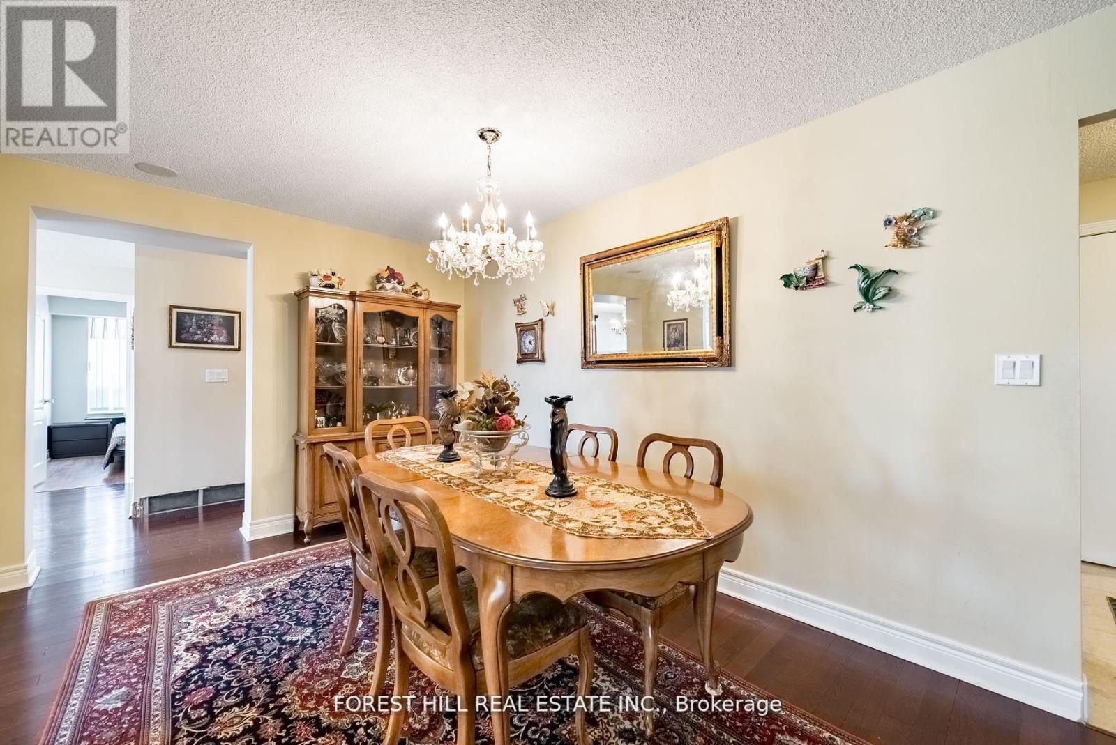 A dining room with a wooden table and chairs.