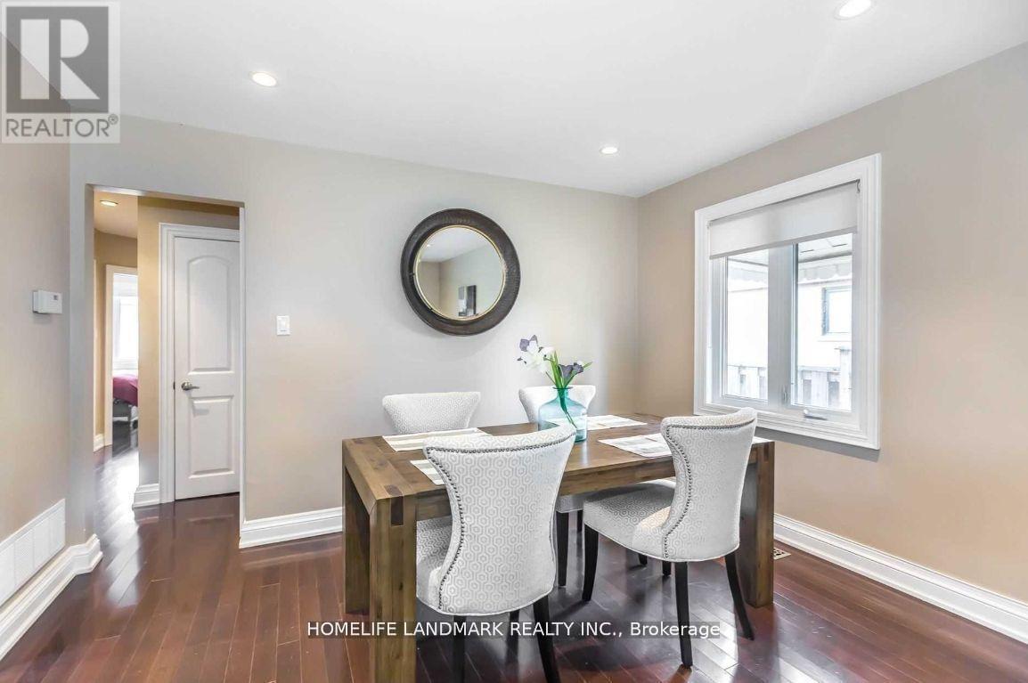 A dining room with a wooden table and chairs.