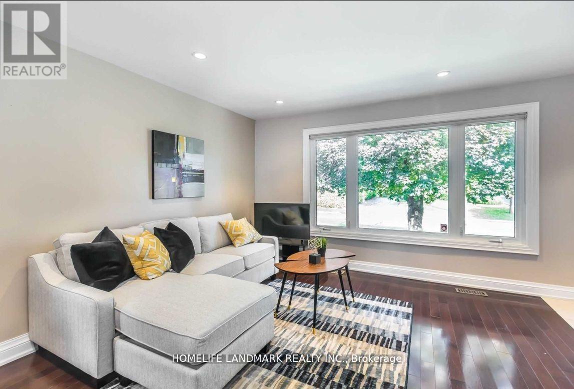A living room with a grey couch and a small table.