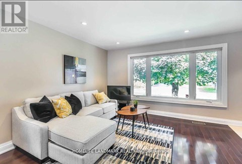 A living room with a grey couch and a small table.
