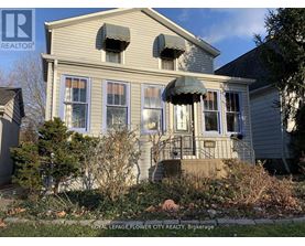 A house with a sign that says Royal LePage Flower City Realty, Brokerage.