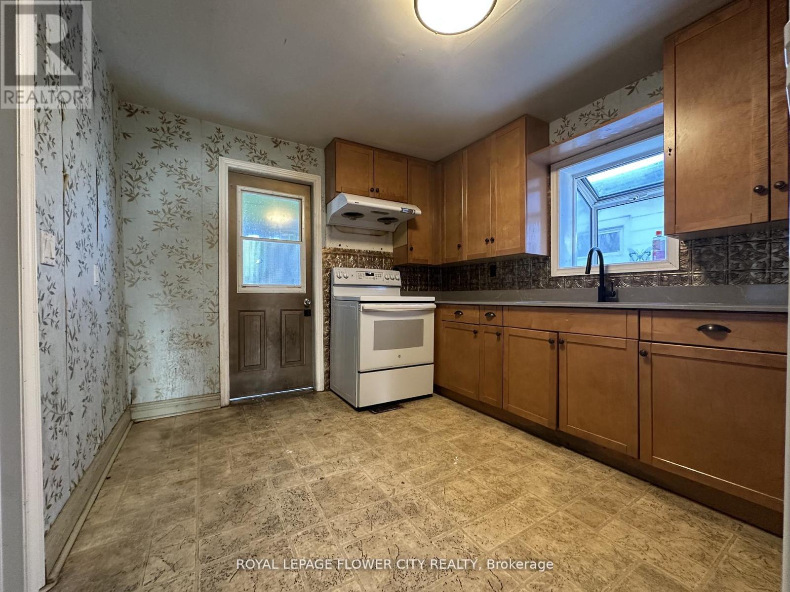 A kitchen with a dishwasher and a stove top oven.