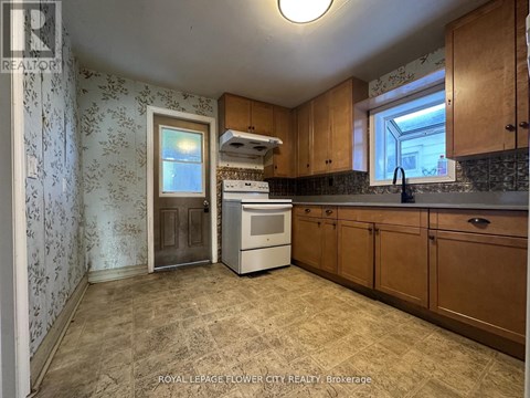 A kitchen with a dishwasher and a stove top oven.