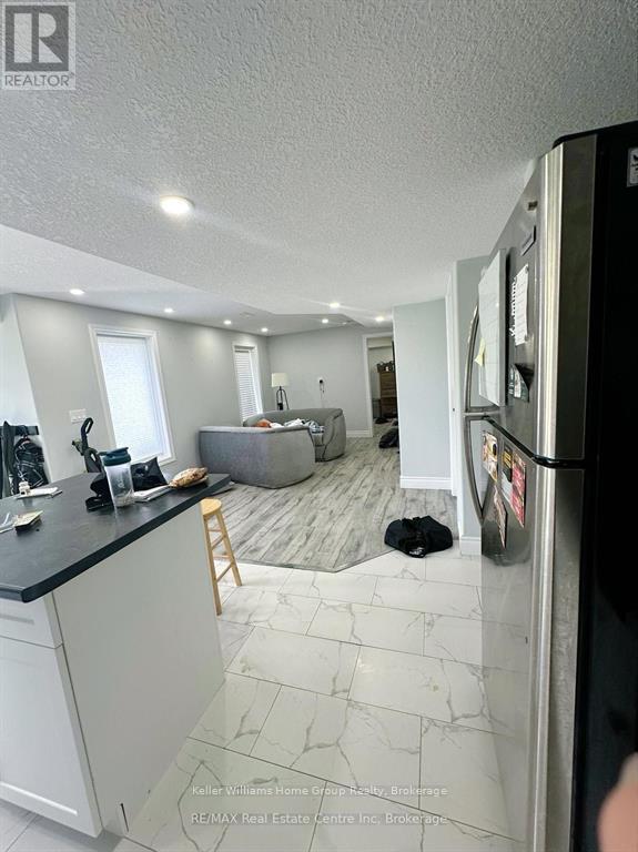 A kitchen with a black counter top and white cabinets.