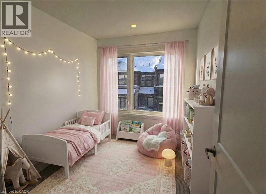 A bedroom with a pink bed and a pink bean bag chair.