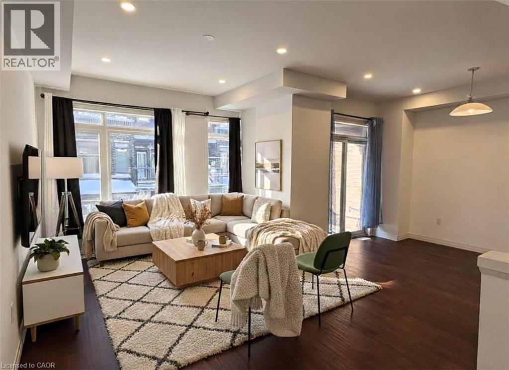A well-lit living room with a large sectional sofa, a coffee table, and a green chair.