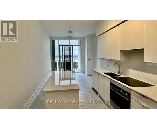 A kitchen with white cabinets and a sink.