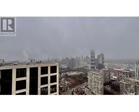 A cityscape with buildings and a hazy sky.