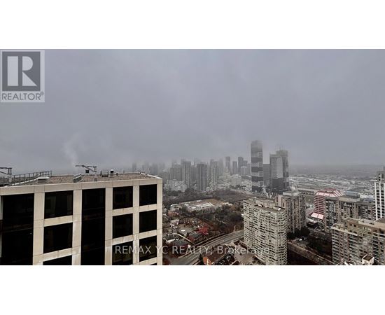 A cityscape with buildings and a hazy sky.